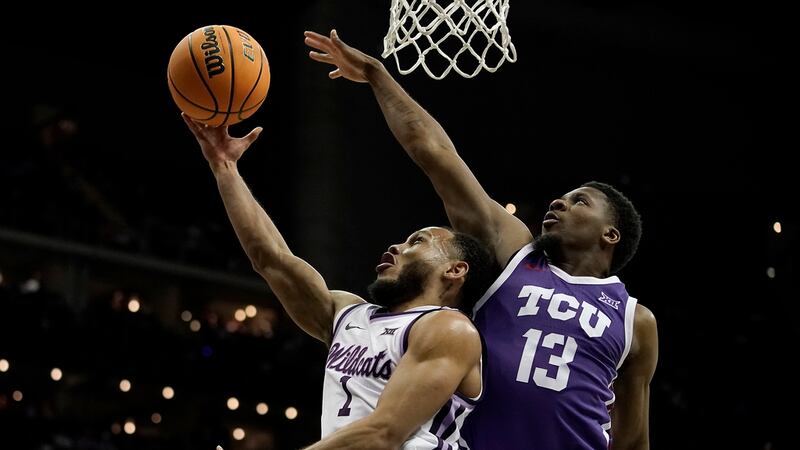 Kansas State guard Markquis Nowell (1) shoots under pressure fromTCU guard Shahada Wells (13)...
