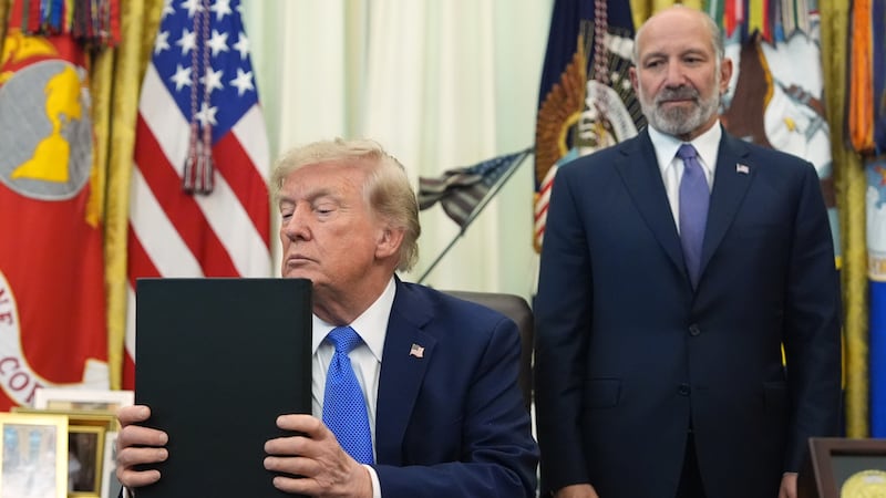 President Donald Trump listens before signing executive orders in the Oval Office of the White...