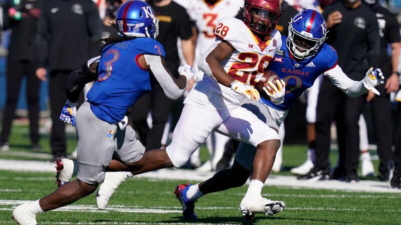 Iowa State running back Breece Hall (28) out runs Kansas safety Ricky Thomas (3) and...