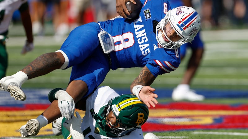 Kansas quarterback Isaiah Marshall (8) is tackled by Baylor defensive end Garrick Ponder (13)...