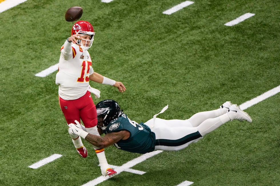 Kansas City Chiefs quarterback Patrick Mahomes (15) passes under pressure by Philadelphia...