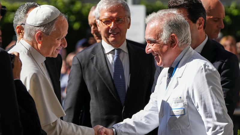 Medical Director Andrea Cambieri, right, greets Pope Leo XIV as he arrives at the Agostino...